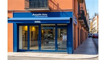 Fachada exterior de la tienda Anzuelo Azul, con el letrero visible y una bicicleta de paso, en una calle típica de Valencia.